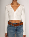 Eyelet pointelle cropped long sleeve
Cropped
Button down closure
Crewneck neckline
Has stretch
Unlined/partial sheer
White cropped long sleeve