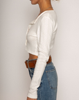Eyelet pointelle cropped long sleeve
Cropped
Button down closure
Crewneck neckline
Has stretch
Unlined/partial sheer
White cropped long sleeve