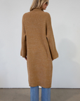 Fuzzy heather knit longline cardigan. Collar neckline. Long sleeves. Front pockets. Open front. Unlined. fall cardigan. tan long cardigan