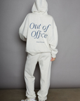 Graphic printed knit sweatset. Elastic waistband and leg openings. Side pockets. Fleece lining. hooded sweater. sweatpant. grey sweatset. out of office sweat set