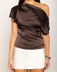 Satin asymmetrical off the shoulder top
Shoulder button closure
Front drape detail
Relaxed fit
Can be worn multiple ways
Side zipper closure
brown satin top
thanksgiving top outfit