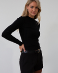 Knit top. Mock neck. Long sleeves. Lettuce edge hems. Unlined. black long sleeve. black ribbed long sleeve. fall top. fall outfit.