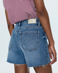 Mid-rise denim short
Medium length
Relaxed fit
Medium blue denim wash
Whiskering and a frayed, distressed hem