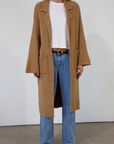 Fuzzy heather knit longline cardigan. Collar neckline. Long sleeves. Front pockets. Open front. Unlined. fall cardigan. tan long cardigan