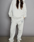 Graphic printed knit sweatset. Elastic waistband and leg openings. Side pockets. Fleece lining. hooded sweater. sweatpant. grey sweatset. out of office sweat set
