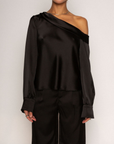 black Satin top. Folded off the shoulder neckline. Long sleeves with button closures. Unlined. black satin off the shoulder top.