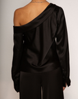 black Satin top. Folded off the shoulder neckline. Long sleeves with button closures. Unlined. black satin off the shoulder top.