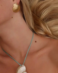 Turbo shell silk cord necklace
Polished and hand-drilled
Silk cord with gold plated beads
Can be worn multiple ways
Length: 26"
Turbo shell approx. 1.5"
Size color and shape of shell may vary slightly