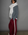 Woven burgundy track pants. Elastic waistband. Side pockets. Side stripes. Unlined. street fashion. trendy track pants