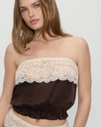 Strapless silk blouse
Gentle elastic to hold itself in place
Lace detailing
Rosette accent at center front
Silk
brown silk tube top