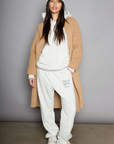 Graphic printed knit sweatset. Elastic waistband and leg openings. Side pockets. Fleece lining. hooded sweater. sweatpant. grey sweatset. out of office sweat set