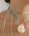 Turbo shell silk cord necklace
Polished and hand-drilled
Silk cord with gold plated beads
Can be worn multiple ways
Length: 26"
Turbo shell approx. 1.5"
Size color and shape of shell may vary slightly