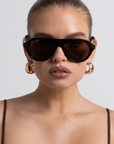 Oversized aviator frame
Featuring a straight brow line
Teardrop-shaped lenses
Distinctive keyhole bridge
Thick, structured frame with sculptural finish
tortoise frame with brown lens aviator sunglasses