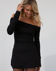 Knit dress. Folded elastic off the shoulder neckline. Long sleeves. Ruched sides. Fully lined. black mini dress. holiday dress. fall dress. friendsgiving outfit. thanksgiving outfit. off the shoulder dress