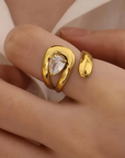 18K Gold Non-Tarnish Wrap CZ Ring
18K Gold Plating
Stainless Steel
Size 7 Measurement: 0.682 Diameter/2.14 Circumference
Lead-free
Nickel-safe
Hypoallergenic
Water Resistant
