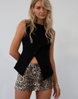 Woven sleeveless top. Asymmetric front button down closures. Back slit. Fully lined. black vest top. going out top. fall outfit. fall top