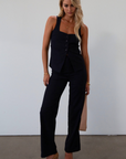 Plaid woven sleeveless top. Front button down closure. Faux front pockets. Adjustable back tie closure. Fully lined. navy blue blouse. work outfit. business casual outfit.