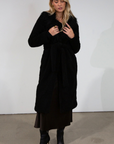 Black Faux sherpa longline coat. Faux fur collar neckline. Front snap button closure. Tie waist. Side pockets. Back slit. Fully lined. long coat. coat for new york. fall coat. fall outfit