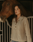 Fuzzy mixed knit crochet sweater. Collar neckline. Front button closures. Long sleeves. Banded hems. Unlined. tan sweater. knit sweater. quarter button up sweater
