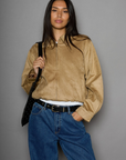 Vegan suede bomber jacket. Collar neckline. Front zipper closure. Elastic hems. Front pockets with snap button closures. Fully lined. tan suede bomber