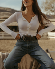 Ribbed knit top. Long sleeves. With elastic sleeve openings. Front button down closures. Unlined. Crochet lace trim. White long sleeve