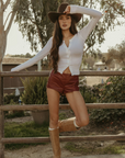 Faux leather shorts. Back hook and eye and zipper closures. Fully lined. red leather shorts. red hot shorts. mini red leather shorts.