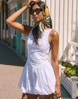 Woven sleeveless dress. Drop waist. Bubble skirt. Side hook and eye and zipper closures. Adjustable lace up back closure. Fully lined. white mini bubble skirt. summer dress. vacation dress. vacation outfit. nice dress. european summer dress. european summer outfit. european summer vacation
