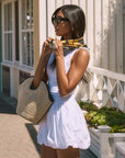 Woven sleeveless dress. Drop waist. Bubble skirt. Side hook and eye and zipper closures. Adjustable lace up back closure. Fully lined. white mini bubble skirt. summer dress. vacation dress. vacation outfit. nice dress. european summer dress. european summer outfit. european summer vacation