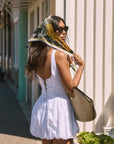 Woven sleeveless dress. Drop waist. Bubble skirt. Side hook and eye and zipper closures. Adjustable lace up back closure. Fully lined. white mini bubble skirt. summer dress. vacation dress. vacation outfit. nice dress. european summer dress. european summer outfit. european summer vacation