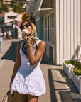 Woven sleeveless dress. Drop waist. Bubble skirt. Side hook and eye and zipper closures. Adjustable lace up back closure. Fully lined. white mini bubble skirt. summer dress. vacation dress. vacation outfit. nice dress. european summer dress. european summer outfit. european summer vacation