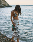 Crochet knit bikini top. Ruffle trim. Adjustable back tie closure. Crochet knit maxi skirt. Elastic waist. Ruffle trim. Unlined. black and white set. black and white skirt set. skirt and crop top set. summer outfit. summer going out set. beach vacation outfit. fancy dinner outfit. european summer outfit. european summer set. european summer outfit inspo. vacation outfit
