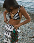 Crochet knit bikini top. Ruffle trim. Adjustable back tie closure. Crochet knit maxi skirt. Elastic waist. Ruffle trim. Unlined. black and white set. black and white skirt set. skirt and crop top set. summer outfit. summer going out set. beach vacation outfit. fancy dinner outfit. european summer outfit. european summer set. european summer outfit inspo. vacation outfit