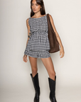 TOP:
Gingham printed flowy tank top
Ruched side ties
Back button closure
Unlined
Length: 21"
Cotton
BOTTOM:
Gingham printed shorts
Elastic waistband
Unlined
Length: 11.5"
Cotton
black and white gingham printed short set
summer set