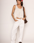 Lace trimmed tank top
Faux front bow tie
Sleeveless
Scoop neckline
Open front with button closure
Unlined
ivory coquette tank top
peasant top
summer flowy tank top