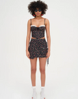Floral printed woven cropped tank top. Adjustable straps. Boning in bodice. Elastic back strap with hook and eye closures. Back zipper closure. Fully lined.