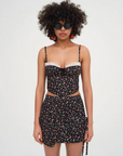 Floral printed woven cropped tank top. Adjustable straps. Boning in bodice. Elastic back strap with hook and eye closures. Back zipper closure. Fully lined.
