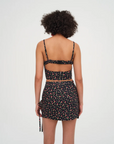 Floral printed woven cropped tank top. Adjustable straps. Boning in bodice. Elastic back strap with hook and eye closures. Back zipper closure. Fully lined.