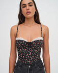 Floral printed woven cropped tank top. Adjustable straps. Boning in bodice. Elastic back strap with hook and eye closures. Back zipper closure. Fully lined.