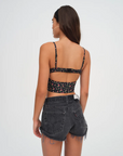 Floral printed woven cropped tank top. Adjustable straps. Boning in bodice. Elastic back strap with hook and eye closures. Back zipper closure. Fully lined.