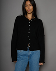 Fuzzy knit cardigan. Crewneck. Front button down closures. Long sleeves. Unlined. black cardigan. fall outfit. fall cardigan. layering piece. layering cardigan