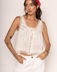 Lace trimmed tank top
Faux front bow tie
Sleeveless
Scoop neckline
Open front with button closure
Unlined
ivory coquette tank top
peasant top
summer flowy tank top