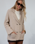 Cable knit cardigan. Double breasted. Collar neckline. Front button down closure. Front pockets. Unlined. oat cardigan sweater. fall sweater. fall outfit
