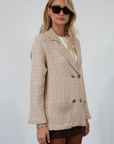 Cable knit cardigan. Double breasted. Collar neckline. Front button down closure. Front pockets. Unlined. oat cardigan sweater. fall sweater. fall outfit