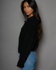 Fuzzy knit cardigan. Crewneck. Front button down closures. Long sleeves. Unlined. black cardigan. fall outfit. fall cardigan. layering piece. layering cardigan