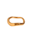 A gold-colored, waved ring with an asymmetrical design on a white background.