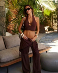 TOP
brow Cropped halter top
Adjustable neck tie
Side zipper closure
Front keyhole with bead detail
resort outfit
BOTTOM
brown Elastic waistband
Comes with hip scarf