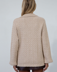 Cable knit cardigan. Double breasted. Collar neckline. Front button down closure. Front pockets. Unlined. oat cardigan sweater. fall sweater. fall outfit