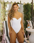 Cheeky white one piece bikini
Adjustable straps
Supportive underwire bra
Tapered fabric across the bust
Nylon/Spandex
white bikini
bridal swimwear
bridal bikini