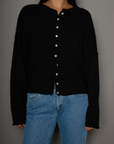 Fuzzy knit cardigan. Crewneck. Front button down closures. Long sleeves. Unlined. black cardigan. fall outfit. fall cardigan. layering piece. layering cardigan