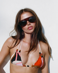 Geometric patterned bikini top
Featuring signature double-string ties and playful beaded accents
Adjustable neck and back tie